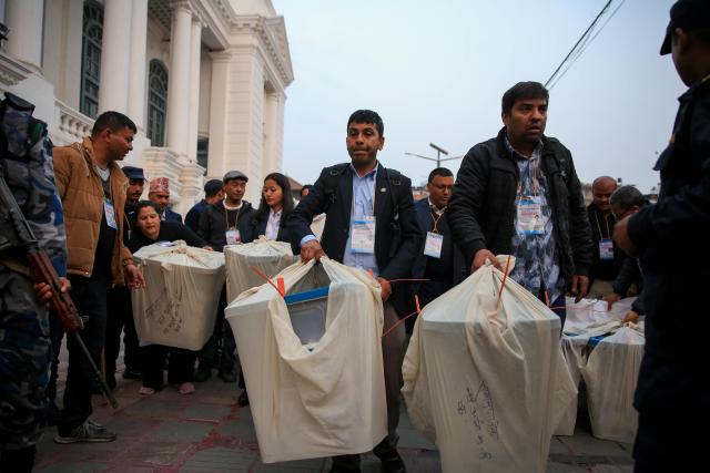 (260305) -- KATHMANDU, March 5, 2026 (Xinhua) -- Staff members take ballot boxes out of a polling station after the voting for the House of Representatives elections concluded in Kathmandu, Nepal, on March 5, 2026. Around 60 percent of eligible voters cast their votes in the House of Representatives elections in Nepal that concluded on Thursday, the top official of the Election Committee said. (Photo by Sulav Shrestha/Xinhua)