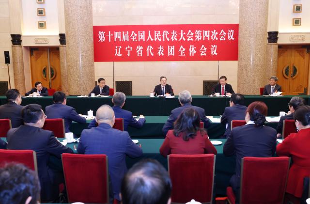 (260305) -- BEIJING, March 5, 2026 (Xinhua) -- Ding Xuexiang, a member of the Standing Committee of the Political Bureau of the Communist Party of China Central Committee and Chinese vice premier, joins his fellow deputies from the delegation of Liaoning Province to deliberate on the government work report at the fourth session of the 14th National People's Congress in Beijing, capital of China, March 5, 2026. (Xinhua/Liu Weibing)