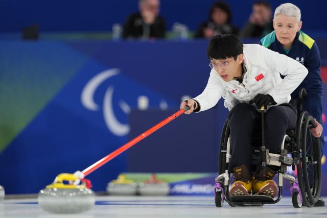 (260306) -- BEIJING, March 6, 2026 (Xinhua) -- Yang Jinqiao of China competes during the wheelchair curling mixed doubles round robin session 1 match between China and Japan at the Milan-Cortina 2026 Paralympic Winter Games in Cortina D'ampezzo, Italy, March 4, 2026. (Xinhua/Lian Yi)