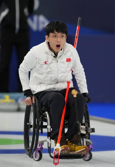 (260306) -- CORTINA D'AMPEZZO, March 6, 2026 (Xinhua) -- Yang Jinqiao of China reacts during the wheelchair curling mixed doubles round robin session 3 match between China and Italy at the Milan-Cortina 2026 Paralympic Winter Games in Cortina D'ampezzo, Italy, March 5, 2026. (Xinhua/Mou Yu)