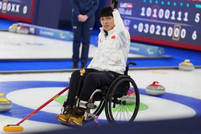 (260306) -- CORTINA D'AMPEZZO, March 6, 2026 (Xinhua) -- Yang Jinqiao of China celebrates after the wheelchair curling mixed doubles round robin session 3 match between China and Italy at the Milan-Cortina 2026 Paralympic Winter Games in Cortina D'ampezzo, Italy, March 5, 2026. (Xinhua/Lian Yi)