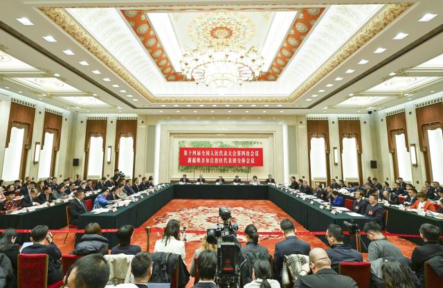 (260306) -- BEIJING, March 6, 2026 (Xinhua) -- A group meeting of deputies from the delegation of Xinjiang Uygur Autonomous Region is held at the fourth session of the 14th National People's Congress (NPC) in Beijing, capital of China, March 6, 2026. (Xinhua/Cheng Tingting)