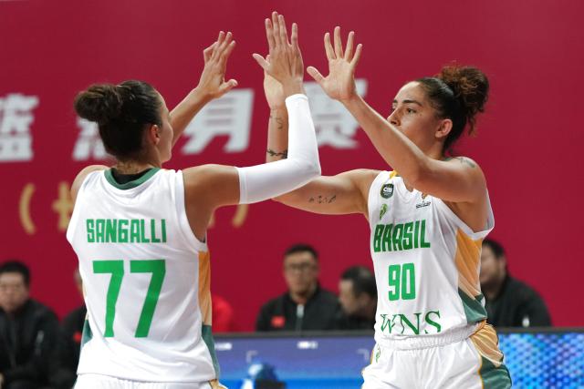 (260306) -- CHANGSHA, March 6, 2026 (Xinhua) -- Aline Cristina Cezario De Moura (R) of Brazil celebrates scoring with her teammate Izabella Frederico Sangalli during a warm up match between China and Brazil in preparation for the 2026 FIBA Women's Basketball World Cup qualifiers in Changsha, central China's Hunan Province, on March 6, 2026. (Xinhua/Chen Zhenhai)