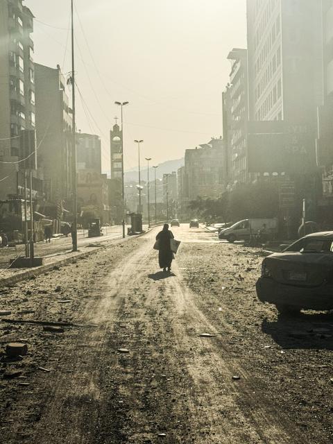 (260306) -- BEIRUT, March 6, 2026 (Xinhua) -- A pedestrian walks on a street full of debris after an Israeli airstrike in Beirut's southern suburbs, Lebanon, March 6, 2026. Dozens of Israeli airstrikes targeted areas across Lebanon overnight and early Friday, striking Beirut's southern suburbs, southern Lebanon and the Bekaa Valley amid escalating military tensions. (Photo by Bilal Jawich/Xinhua)