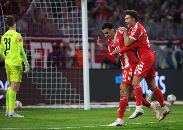 (260307) -- MUNICH, March 7, 2026 (Xinhua) -- Jamal Musiala (C) and Tom Bischof (R) of FC Bayern Munich celebrate scoring during the German first division Bundesliga football match between FC Bayern Munich and Borussia Moenchengladbach in Munich, Germany, March 6, 2026. (Photo by Philippe Ruiz/Xinhua)