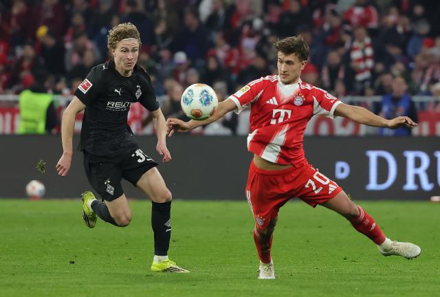 (260307) -- MUNICH, March 7, 2026 (Xinhua) -- Tom Bischof (R) of FC Bayern Munich vies with Hugo Bolin of Borussia Moenchengladbach during the German first division Bundesliga football match between FC Bayern Munich and Borussia Moenchengladbach in Munich, Germany, March 6, 2026. (Photo by Philippe Ruiz/Xinhua)