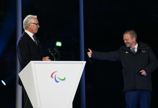 (260307) -- VERONA, March 7, 2026 (Xinhua) -- Milan-Cortina 2026 Organising Committee President Giovanni Malago (L) and International Paralympic Committee President Andrew Parsons react during the opening ceremony of Milan-Cortina 2026 Paralympic Winter Games at Verona Olympic Arena in Verona, Italy, March 6, 2026. (Xinhua/Li Jing)