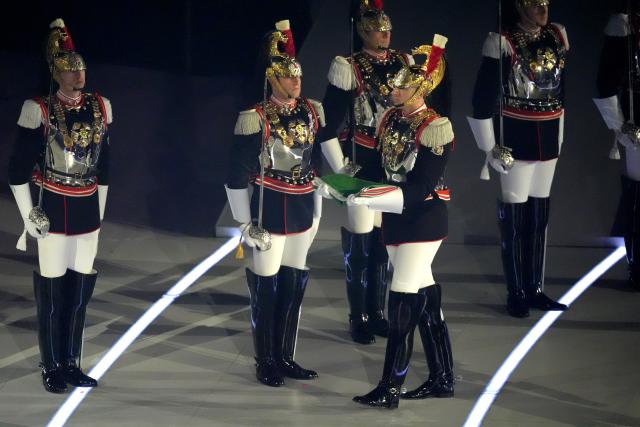 (260307) -- VERONA, March 7, 2026 (Xinhua) -- The Italian national flag is carried onto the stage during the opening ceremony of Milan-Cortina 2026 Paralympic Winter Games at Verona Olympic Arena in Verona, Italy, March 6, 2026. (Xinhua/Cai Yang)