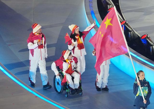 (260307) -- VERONA, March 7, 2026 (Xinhua) -- Members of the delegation of China parade during the opening ceremony of Milan-Cortina 2026 Paralympic Winter Games at Verona Olympic Arena in Verona, Italy, March 6, 2026. (Xinhua/Mu Yu)