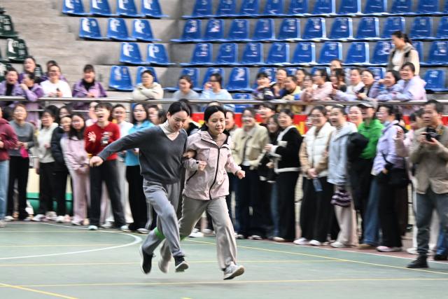 (260307) -- BEIJING, March 7, 2026 (Xinhua) -- Women participate in a competition at a fun sports event in Luocheng Mulao Autonomous County, Hechi City, south China's Guangxi Zhuang Autonomous Region, March 6, 2026. Various events were held across China recently to mark International Women's Day. (Photo by Wei Rudai/Xinhua)