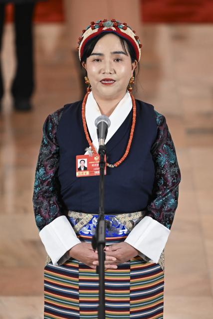 (260307) -- BEIJING, March 7, 2026 (Xinhua) -- Mikyi Tsomo, a member of the 14th National Committee of the Chinese People's Political Consultative Conference (CPPCC), attends a group interview ahead of the second plenary meeting of the fourth session of the 14th CPPCC National Committee at the Great Hall of the People in Beijing, capital of China, March 7, 2026. (Xinhua/Cao Yiming)
