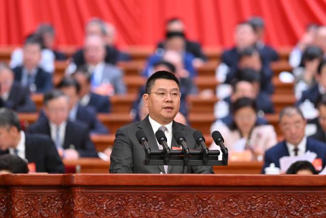 (260307) -- BEIJING, March 7, 2026 (Xinhua) -- Wang Junjin, a member of the 14th National Committee of the Chinese People's Political Consultative Conference (CPPCC), speaks at the second plenary meeting of the fourth session of the 14th CPPCC National Committee at the Great Hall of the People in Beijing, capital of China, March 7, 2026. (Xinhua/Li Tao)