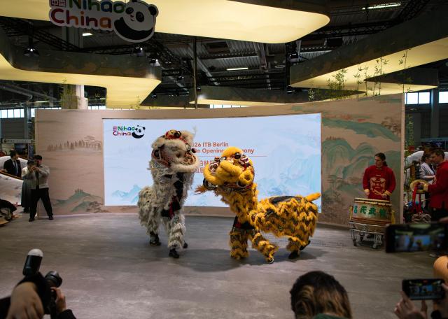 (260307) -- BERLIN, March 7, 2026 (Xinhua) -- A lion dance is staged at the China pavilion during ITB Berlin 2026 in Berlin, Germany, on March 3, 2026. TO GO WITH "Feature: A cultural encounter with 'Nihao China' at Berlin tourism trade fair" (Xinhua/Zhang Haofu)
