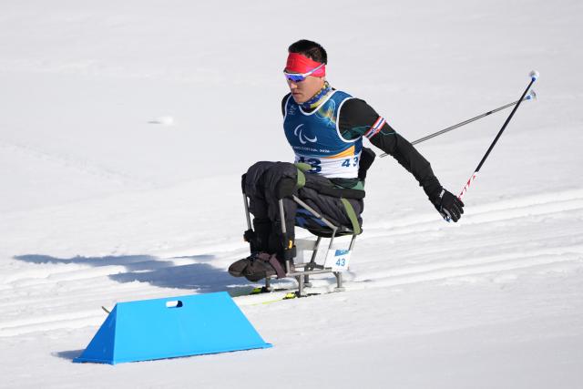 (260307) -- TESERO, March 7, 2026 (Xinhua) -- Mao Zhongwu of China competes during the men's sprint sitting final of para biathon at the Milan-Cortina 2026 Paralympic Winter Games in Tesero, Italy, March 7, 2026. (Xinhua/Lian Zhen)