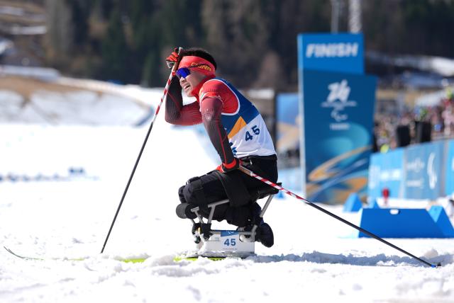 (260307) -- TESERO, March 7, 2026 (Xinhua) -- Liu Mengtao of China reacts after the men's sprint sitting final of para biathon at the Milan-Cortina 2026 Paralympic Winter Games in Tesero, Italy, March 7, 2026. (Xinhua/Hou Zhaokang)