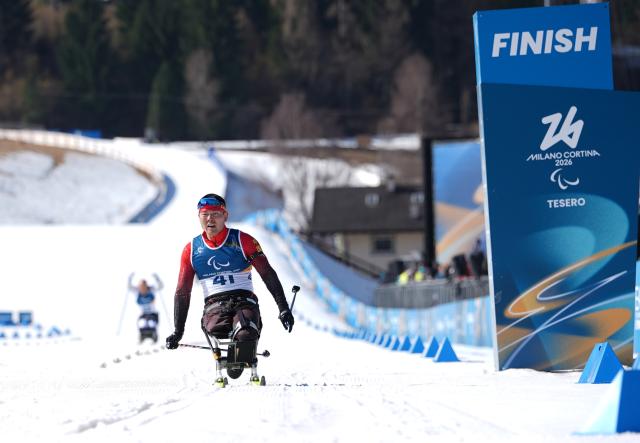 (260307) -- TESERO, March 7, 2026 (Xinhua) -- Wang Tao of China reacts after the men's sprint sitting final of para biathon at the Milan-Cortina 2026 Paralympic Winter Games in Tesero, Italy, March 7, 2026. (Xinhua/Hou Zhaokang)