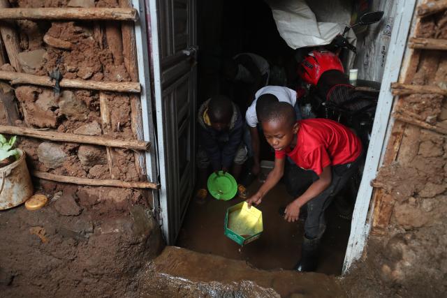 (260307) -- NAIROBI, March 7, 2026 (Xinhua) -- Boys drain the rain water out of a house after a heavy rain in Kibera of Nairobi, Kenya, on March 7, 2026. The death toll from heavy overnight rainfall that triggered severe flooding across several parts of the Kenyan capital, Nairobi, has risen to 23 as rescue teams continue searching for survivors, police confirmed on Saturday. (Photo by Henry Naminde/Xinhua)