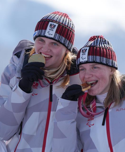 (260307) -- CORTINA D'AMPEZZO, March 7, 2026 (Xinhua) -- Veronika Aigner (L) of Austria celebrates with her guide during the awarding ceremony for para alpine skiing women's downhill vision impaired match at the Milan-Cortina 2026 Paralympic Winter Games in Cortina D'ampezzo, Italy, March 7, 2026. (Xinhua/Wang Kaiyan)