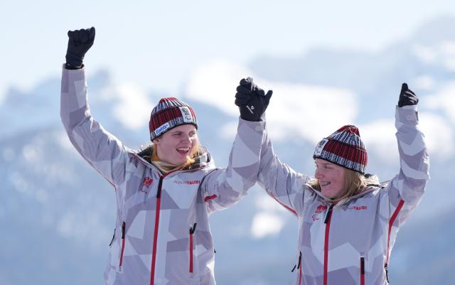 (260307) -- CORTINA D'AMPEZZO, March 7, 2026 (Xinhua) -- Veronika Aigner (L) of Austria celebrates with her guide during the awarding ceremony for para alpine skiing women's downhill vision impaired match at the Milan-Cortina 2026 Paralympic Winter Games in Cortina D'ampezzo, Italy, March 7, 2026. (Xinhua/Wang Kaiyan)