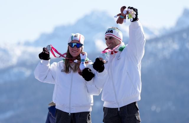 (260307) -- CORTINA D'AMPEZZO, March 7, 2026 (Xinhua) -- Chiara Mazzel (L) of Italy celebrates with her guide during the awarding ceremony for para alpine skiing women's downhill vision impaired match at the Milan-Cortina 2026 Paralympic Winter Games in Cortina D'ampezzo, Italy, March 7, 2026. (Xinhua/Wang Kaiyan)