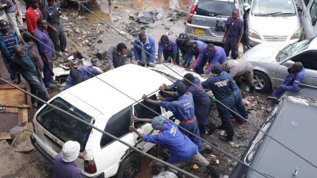 (260307) -- NAIROBI, March 7, 2026 (Xinhua) -- People clean the street after floods in Nairobi, capital of Kenya, March 7, 2026. The death toll from heavy overnight rainfall that triggered severe flooding across several parts of the Kenyan capital, Nairobi, has risen to 23 as rescue teams continue searching for survivors, police confirmed on Saturday. (Photo by John Okoyo/Xinhua)