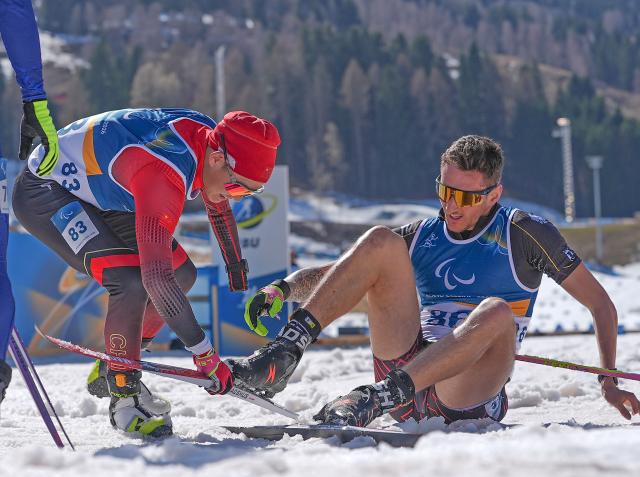(260308) -- TESERO, March 8, 2026 (Xinhua) -- Cai Jiayun (L) of China helps Marco Maier of Germany after the para biathlon men's sprint at the Milan-Cortina 2026 Paralympic Winter Games in Tesero, Italy, March 7, 2026. (Xinhua/Hou Zhaokang)