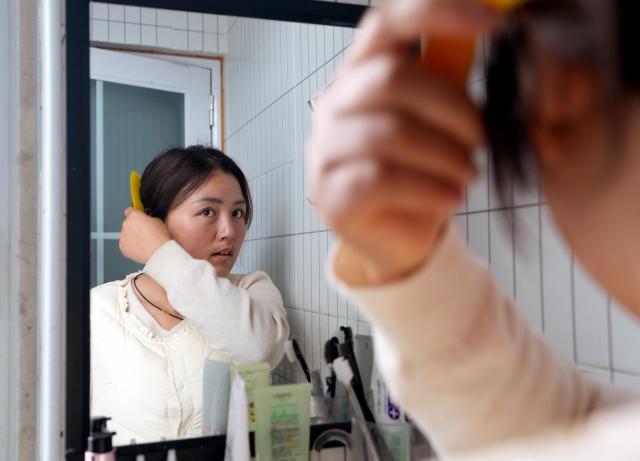 (260307) -- SHANGHAI, March 7, 2026 (Xinhua) -- Tian Dan tidies up before work at her home in Shanghai, east China, on March 4, 2026.
  Tian Dan, 37, is a delivery worker and mother of two. In 2021, Tian left her hometown in Hanzhong of northwest China's Shaanxi Province, to work as a delivery rider in Shanghai. In her early days on the job, she faced setbacks such as getting lost and falling off her motorbike. But with perseverance, she gradually grew and came to realize the value of her profession.  
  In 2024, Tian signed up for the country's continuing education initiative, which is designed to help working individuals to pursue further education, and became one of the first batch of delivery riders to attend university for free. Today, she has graduated from junior college and enrolled to pursue a bachelor's degree.
  Recently, the 37-year-old was awarded China's 2025 March 8th Red-Banner Individual Holder, one of the highest honors given to the country's outstanding women by the All-China Women's Federation.
  After receiving the national honor, Tian is aware of greater responsibilities she should shoulder to help more riders in their work, life and development. (Xinhua/Liu Ying)