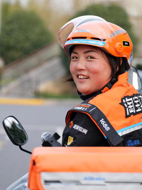 (260307) -- SHANGHAI, March 7, 2026 (Xinhua) -- Tian Dan is pictured in Shanghai, east China, on Feb. 28, 2026.
  Tian Dan, 37, is a delivery worker and mother of two. In 2021, Tian left her hometown in Hanzhong of northwest China's Shaanxi Province, to work as a delivery rider in Shanghai. In her early days on the job, she faced setbacks such as getting lost and falling off her motorbike. But with perseverance, she gradually grew and came to realize the value of her profession.  
  In 2024, Tian signed up for the country's continuing education initiative, which is designed to help working individuals to pursue further education, and became one of the first batch of delivery riders to attend university for free. Today, she has graduated from junior college and enrolled to pursue a bachelor's degree.
  Recently, the 37-year-old was awarded China's 2025 March 8th Red-Banner Individual Holder, one of the highest honors given to the country's outstanding women by the All-China Women's Federation.
  After receiving the national honor, Tian is aware of greater responsibilities she should shoulder to help more riders in their work, life and development. (Xinhua/Liu Ying)