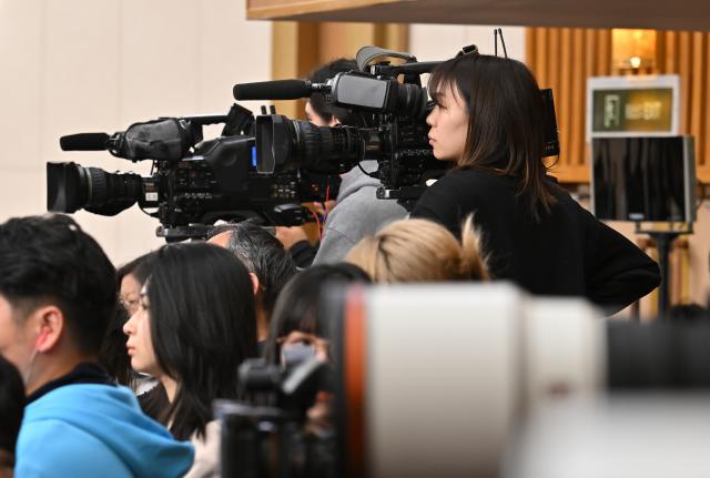 (260308) -- BEIJING, March 8, 2026 (Xinhua) -- Journalists work at a press conference attended by Chinese Foreign Minister Wang Yi on the sidelines of the fourth session of the 14th National People's Congress (NPC) in Beijing, capital of China, March 8, 2026. Wang, also a member of the Political Bureau of the Communist Party of China Central Committee, answered questions of journalists from home and abroad on China's foreign policy and external relations during the press conference on Sunday. (Xinhua/Li Xin)