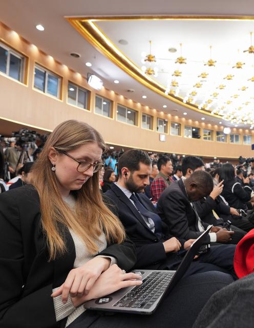 (260308) -- BEIJING, March 8, 2026 (Xinhua) -- Journalists work at a press conference attended by Chinese Foreign Minister Wang Yi on the sidelines of the fourth session of the 14th National People's Congress (NPC) in Beijing, capital of China, March 8, 2026. Wang, also a member of the Political Bureau of the Communist Party of China Central Committee, answered questions of journalists from home and abroad on China's foreign policy and external relations during the press conference on Sunday. (Xinhua/Wang Xi)