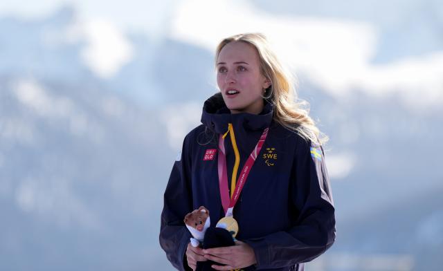 (260308) -- CORTINA D'AMPEZZO, March 8, 2026 (Xinhua) -- Gold medalist Ebba Aarsjoe of Sweden reacts during the awarding ceremony after the para alpine skiing women's downhill standing match at the Milan-Cortina 2026 Paralympic Winter Games in Cortina D'ampezzo, Italy, March 7, 2026. (Xinhua/Wang Kaiyan)