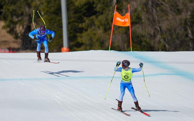 (260308) -- CORTINA D'AMPEZZO, March 8, 2026 (Xinhua) -- Giacomo Bertagnolli (L) of Italy competes with his guide Andrea Ravelli during the para alpine skiing men's downhill vision impaired match at the Milan-Cortina 2026 Paralympic Winter Games in Cortina D'ampezzo, Italy, March 7, 2026. (Xinhua/Wang Kaiyan)
