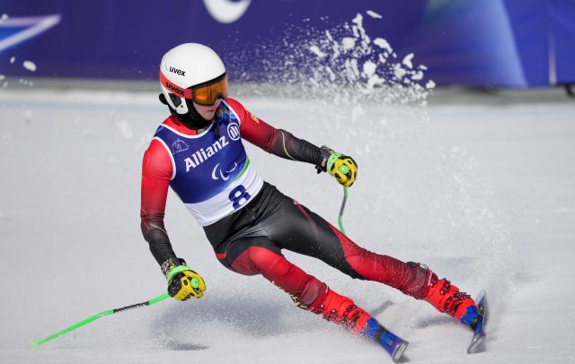 (260308) -- CORTINA D'AMPEZZO, March 8, 2026 (Xinhua) -- Wang Xingdong of China competes during the para alpine skiing men's downhill vision impaired match at the Milan-Cortina 2026 Paralympic Winter Games in Cortina D'ampezzo, Italy, March 7, 2026. (Xinhua/Wang Kaiyan)