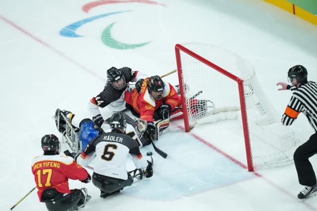 (260308) -- MILAN, March 8, 2026 (Xinhua) -- Players of China and Germany compete during the Para Ice Hockey preliminary round Group A match between China and Germany at the Milan-Cortina 2026 Paralympic Winter Games in Milan, Italy, March 7, 2026. (Xinhua/Li Jing)