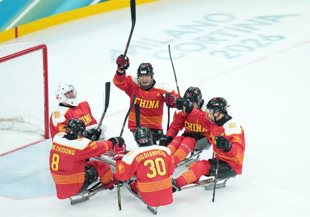 (260308) -- MILAN, March 8, 2026 (Xinhua) -- Players of China cheer up during the Para Ice Hockey preliminary round Group A match between China and Germany at the Milan-Cortina 2026 Paralympic Winter Games in Milan, Italy, March 7, 2026. (Xinhua/Li Jing)