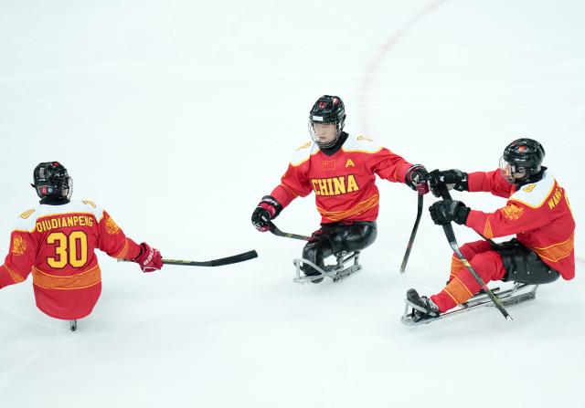 (260308) -- MILAN, March 8, 2026 (Xinhua) -- Players of China celebrate a goal during the Para Ice Hockey preliminary round Group A match between China and Germany at the Milan-Cortina 2026 Paralympic Winter Games in Milan, Italy, March 7, 2026. (Xinhua/Li Jing)