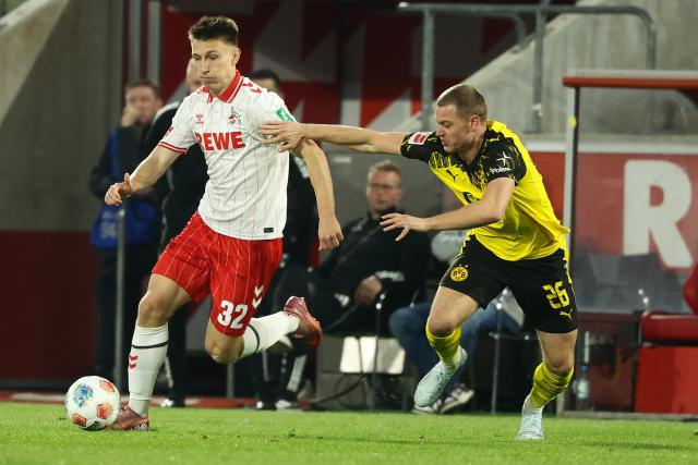 (260308) -- COLOGNE, March 8, 2026 (Xinhua) -- Kristoffer Lund (L) of FC Cologne vies with Julian Ryerson of Borussia Dortmund during the German first division Bundesliga football match between FC Cologne and Borussia Dortmund in Cologne, Germany, March 7, 2026. (Photo by Joachim Bywaletz/Xinhua)