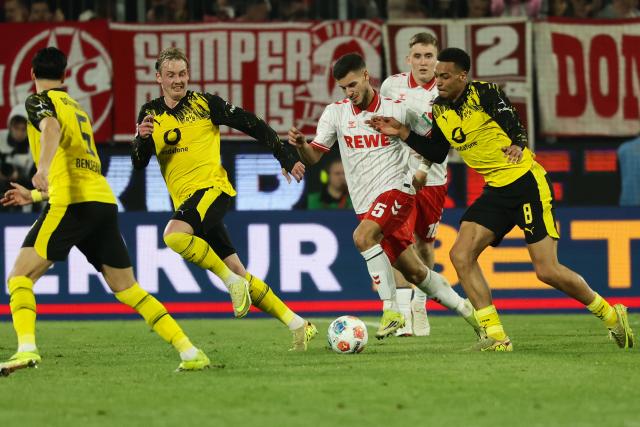 (260308) -- COLOGNE, March 8, 2026 (Xinhua) -- Tom Krauss (C) of FC Cologne breaks through during the German first division Bundesliga football match between FC Cologne and Borussia Dortmund in Cologne, Germany, March 7, 2026. (Photo by Joachim Bywaletz/Xinhua)