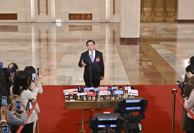 (260309) -- BEIJING, March 9, 2026 (Xinhua) -- Chinese Minister of Agriculture and Rural Affairs Han Jun gives an interview after the second plenary meeting of the fourth session of the 14th National People's Congress (NPC) at the Great Hall of the People in Beijing, capital of China, March 9, 2026. (Xinhua/Li Xin)