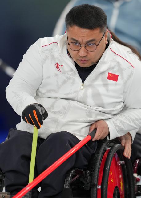 (260310) -- CORTINA D'AMPEZZO, March 10, 2026 (Xinhua) -- Wang Haitao of China competes during the wheelchair curling mixed team round robin session 6 match between China and Norway at the Milan-Cortina 2026 Paralympic Winter Games in Cortina D'ampezzo, Italy, March 9, 2026. (Xinhua/Wang Kaiyan)