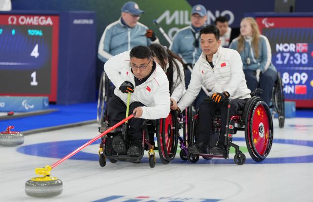 (260310) -- CORTINA D'AMPEZZO, March 10, 2026 (Xinhua) -- Wang Haitao (front) of China competes during the wheelchair curling mixed team round robin session 6 match between China and Norway at the Milan-Cortina 2026 Paralympic Winter Games in Cortina D'ampezzo, Italy, March 9, 2026. (Xinhua/Wang Kaiyan)