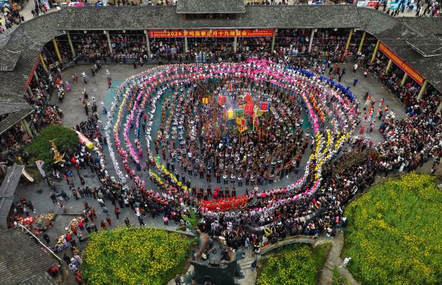 (260310) -- BEIJING, March 10, 2026 (Xinhua) -- An aerial drone photo shows Miao people playing Lusheng during the "pohui" festival in a Miao ethnic village of Rongshui Miao Autonomous County, Liuzhou City, south China's Guangxi Zhuang Autonomous Region, March 7, 2026.
  "Pohui" festival, a local folk festival, was held in Rongshui Miao Autonomous County around the Spring Festival this year. People dressed in festive costumes came together to pray for blessings, share joy of life and entertain themselves. 
   In recent years, thanks to the funds support from Guangdong Province under a "pairing-up" initiative, local authorities have leveraged the ethnic cultural resources to develop local cultural tourism industry, with the aim of promoting rural revitalization. (Photo by Long Linzhi/Xinhua)