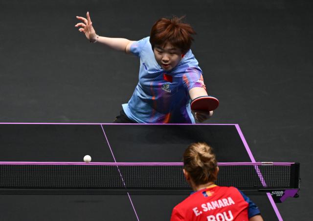 (260310) -- CHONGQING, March 10, 2026 (Xinhua) -- Kuai Man of China hits a return during the women's singles round of 32 match against Elizabeta Samara of Romania at the WTT Champions Chongqing 2026 in southwest China's Chongqing, March 10, 2026. (Xinhua/Chen Cheng)