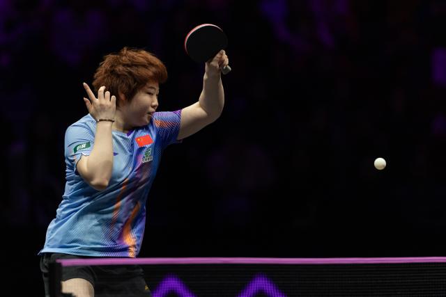 (260310) -- CHONGQING, March 10, 2026 (Xinhua) -- Kuai Man of China hits a return during the women's singles round of 32 match against Elizabeta Samara of Romania at the WTT Champions Chongqing 2026 in southwest China's Chongqing, March 10, 2026. (Xinhua/Huang Wei)