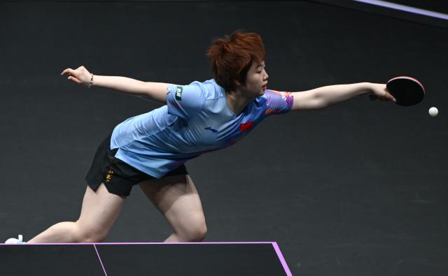 (260310) -- CHONGQING, March 10, 2026 (Xinhua) -- Kuai Man of China hits a return during the women's singles round of 32 match against Elizabeta Samara of Romania at the WTT Champions Chongqing 2026 in southwest China's Chongqing, March 10, 2026. (Xinhua/Chen Cheng)