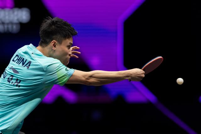 (260310) -- CHONGQING, March 10, 2026 (Xinhua) -- Zhou Qihao of China hits a return during the men's singles round of 32 match against Huang Youzheng of China at the WTT Champions Chongqing 2026 in southwest China's Chongqing, March 10, 2026. (Xinhua/Huang Wei)