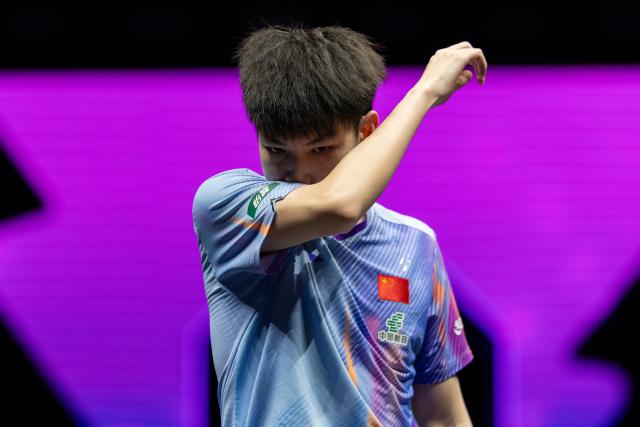 (260310) -- CHONGQING, March 10, 2026 (Xinhua) -- Huang Youzheng of China reacts during the men's singles round of 32 match against Zhou Qihao of China at the WTT Champions Chongqing 2026 in southwest China's Chongqing, March 10, 2026. (Xinhua/Huang Wei)