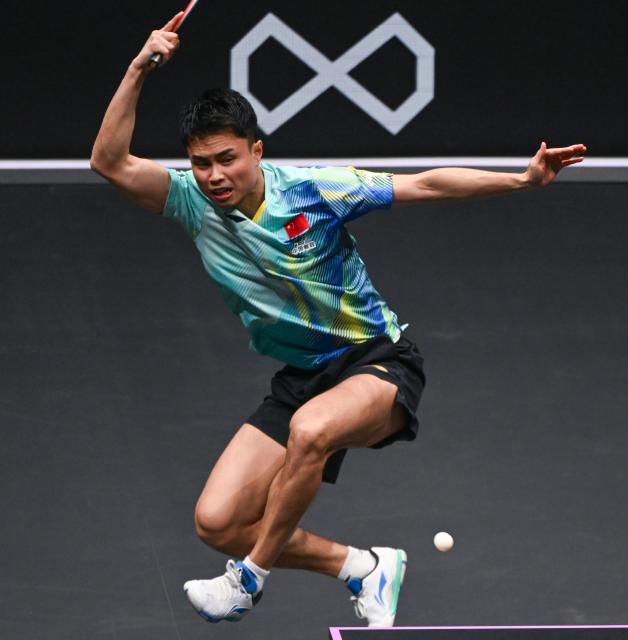 (260310) -- CHONGQING, March 10, 2026 (Xinhua) -- Zhou Qihao of China hits a return during the men's singles round of 32 match against Huang Youzheng of China at the WTT Champions Chongqing 2026 in southwest China's Chongqing, March 10, 2026. (Xinhua/Chen Cheng)