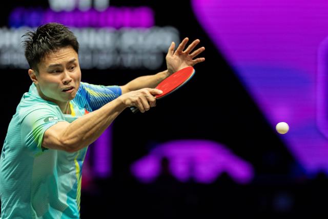(260310) -- CHONGQING, March 10, 2026 (Xinhua) -- Zhou Qihao of China hits a return during the men's singles round of 32 match against Huang Youzheng of China at the WTT Champions Chongqing 2026 in southwest China's Chongqing, March 10, 2026. (Xinhua/Huang Wei)