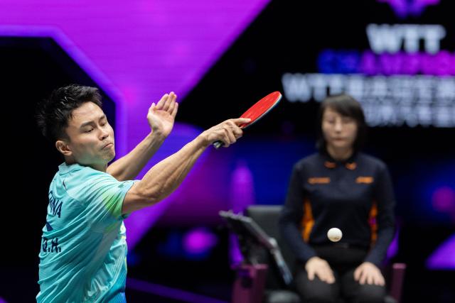 (260310) -- CHONGQING, March 10, 2026 (Xinhua) -- Zhou Qihao of China hits a return during the men's singles round of 32 match against Huang Youzheng of China at the WTT Champions Chongqing 2026 in southwest China's Chongqing, March 10, 2026. (Xinhua/Huang Wei)